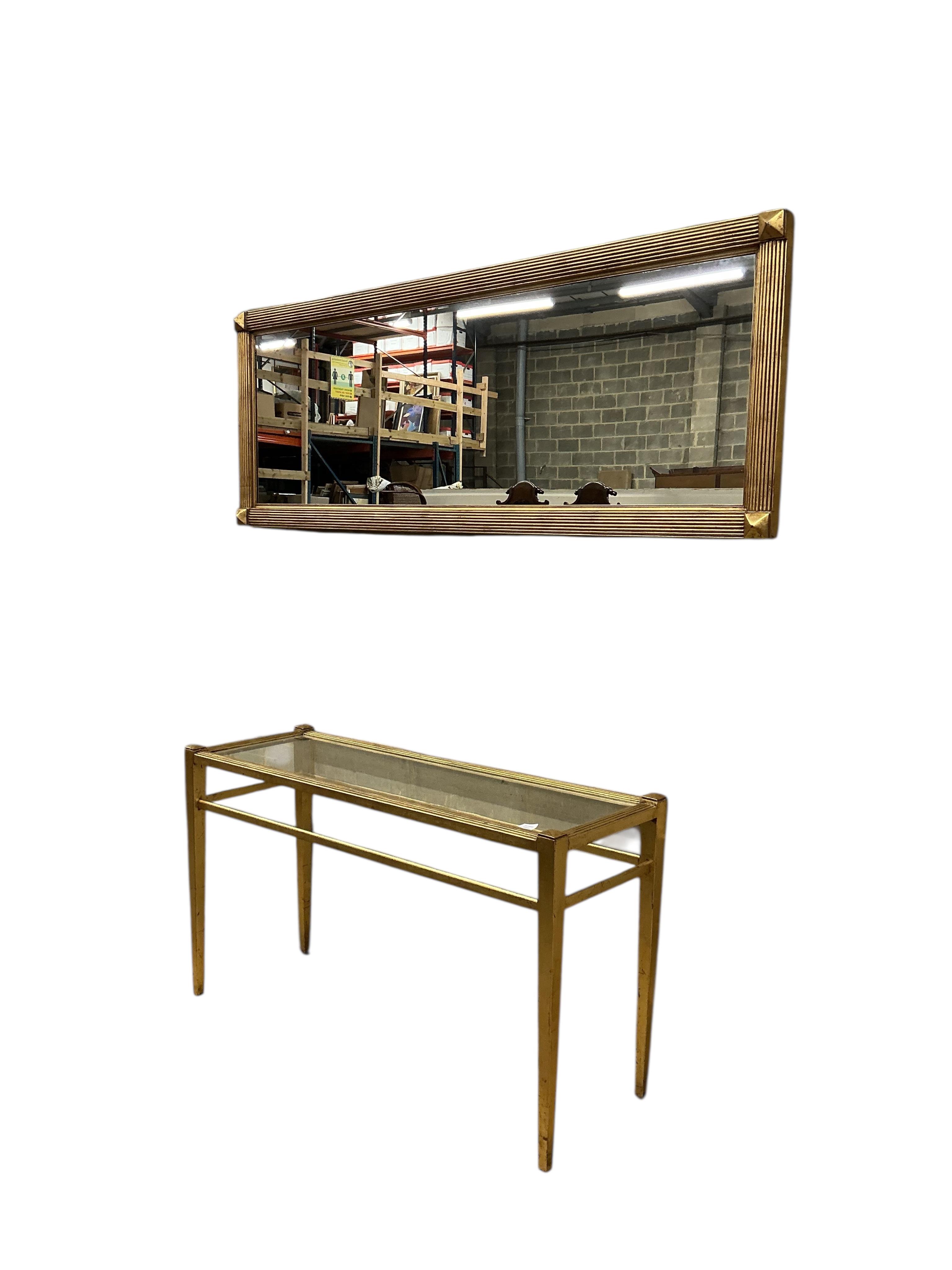A reproduction gilt composition glass top console table, width 138cm, depth 46cm, height 78cm and a mirror